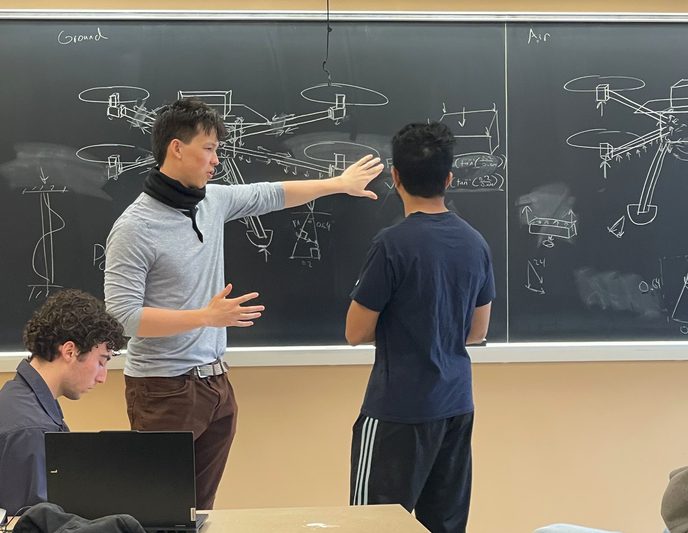 A lead explaining the aircraft load path at the board